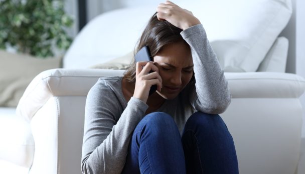 Sad,Woman,Complaining,Sitting,On,The,Floor,Talking,On,Phone