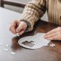 Cropped,View,Of,Senior,Man,Playing,With,Puzzles