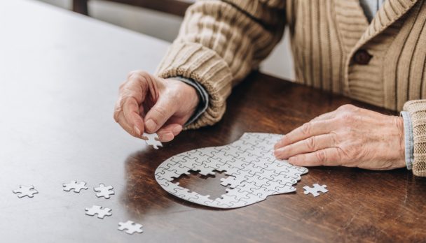 Cropped,View,Of,Senior,Man,Playing,With,Puzzles