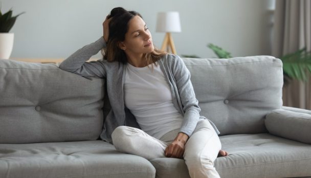 Peaceful,Thoughtful,Young,Mixed,Race,Woman,Sitting,On,Cozy,Sofa