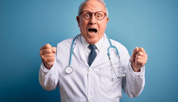 Senior,Grey,Haired,Doctor,Man,Wearing,Stethoscope,And,Medical,Coat