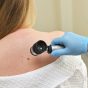 A,Dermatologist,Oncologist,Uses,A,Dermatoscope,To,Examine,Moles,And